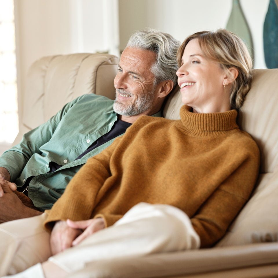 Couple relaxing on a Stressless sofa in sand leather