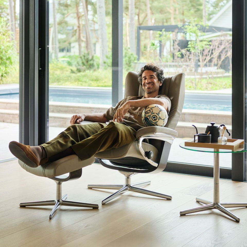 Stressless recliner in Paloma Mushroom leather by a large window